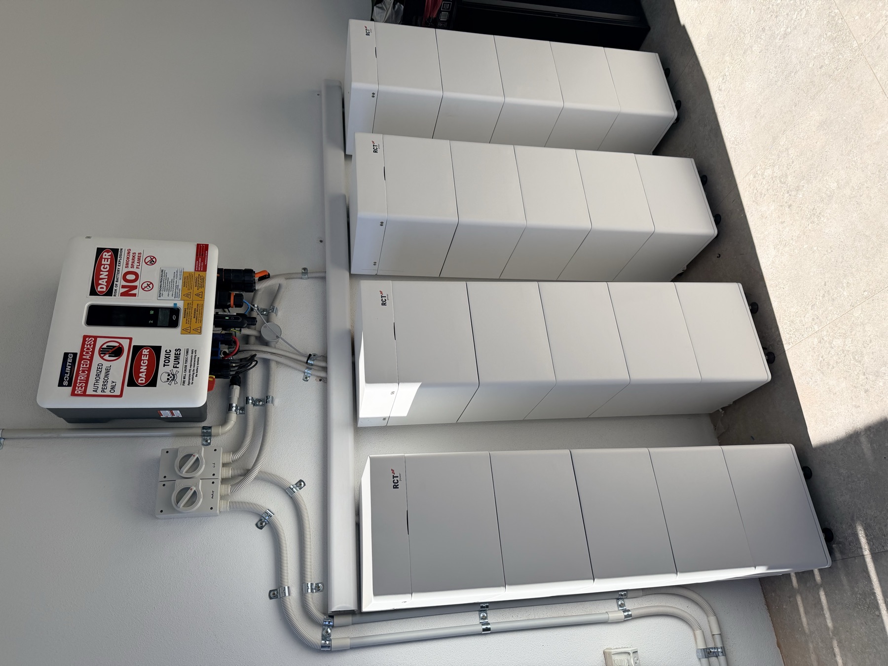Bank of four RCT Power battery towers with switchboard