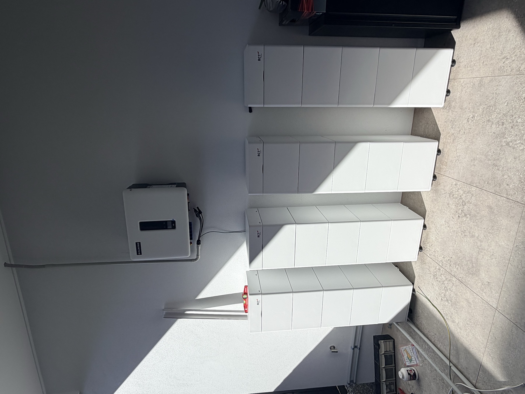 Four RCT Power battery towers with hybrid inverter under the alfresco