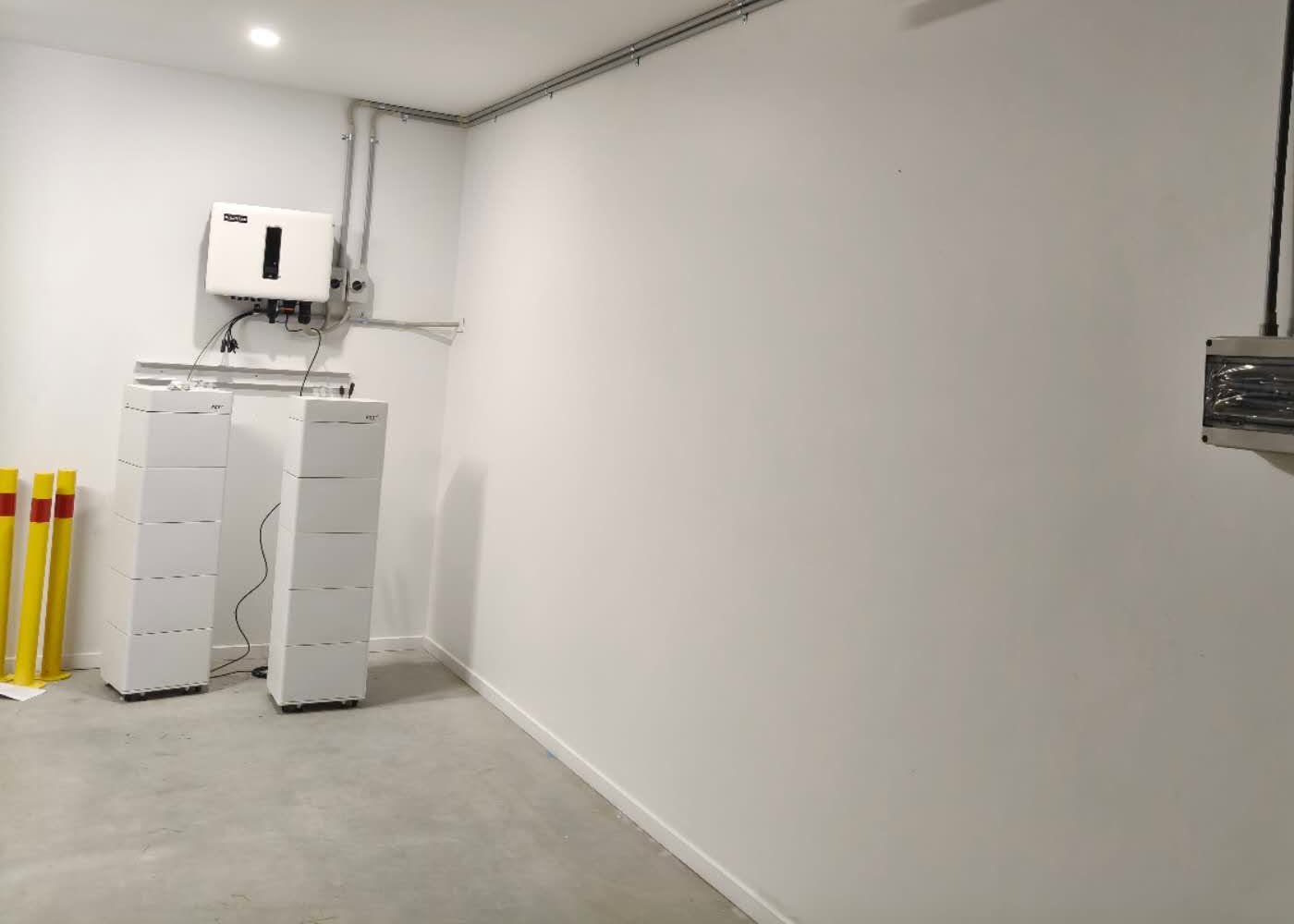 Two RCT Power battery towers with hybrid inverter and EV charger in the garage