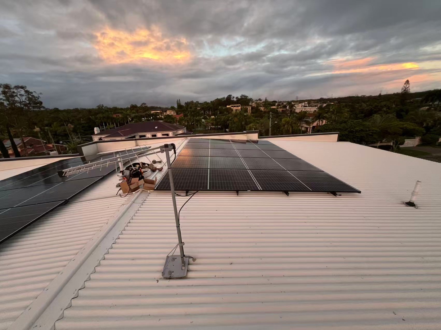 Completed rooftop solar array at sunset